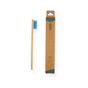The Me Mother Earth Kids Colorful Bamboo Toothbrush with castor oil bristles is displayed beside its brown cardboard box packaging, emphasizing eco-friendly oral care against a white background.