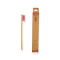 The Me Mother Earth Kids Colorful Bamboo Toothbrush with Castor Oil Bristles is displayed beside its brown cardboard box, both promoting sustainable oral care against a white background.