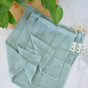 Me Mother Earth Cotton Mesh Produce Bags-3 Pack in light blue with drawstrings and small tags are displayed on a white surface next to a wooden board and green leaves—ideal, eco-friendly reusable grocery bags for all your shopping needs.