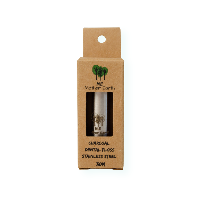 A box of Me Mother Earth Refillable Charcoal Dental Floss, 30M, includes a stainless steel container shown through an eco-friendly brown package window—refillable and sustainable oral care.