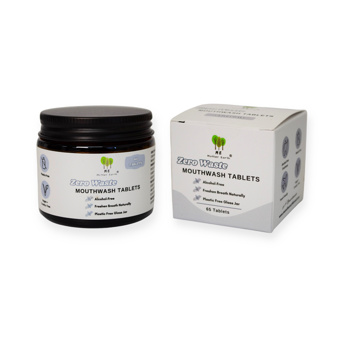 A glass jar and box labeled Me Mother Earth Mouthwash Tablets - Zero Waste, Alcohol Free, with 65 tablets in plastic-free white packaging featuring green and blue text plus eco-friendly icons.