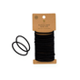 Me Mother Earth Hair Ties are made from organic cotton and natural rubber. This pack of 20 plastic-free hair ties is displayed on a brown cardboard backing, with two natural rubber ties shown separately next to the pack.