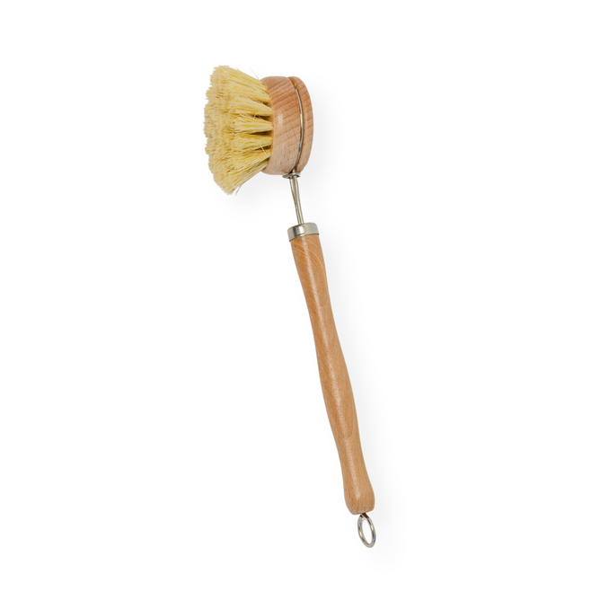 The Me Mother Earth Sisal Kitchen Brush features stiff, light-colored bristles and a rounded head. This eco-friendly brush has a metal ring on the handle for hanging and is pictured against a white background.