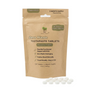 A brown refill pouch labeled "Me Mother Earth Toothpaste Tablets 3 Month Refill - Fluoride-Free, Peppermint" features plant-based and enamel-supporting details. Small white toothpaste tablets are displayed in front of the pouch.