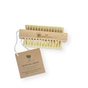 The Wood Nail Brush by Me Mother Earth features stiff bristles, a handy string, and comes with a brown branded tag displaying product details. This nail brush is plastic-free.