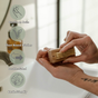 A person uses the Me Mother Earth Wood Nail Brush with plant-based bristles at a sink. Text and icons spotlight its gentle, double-sided, earth-friendly, and plastic-free design for an eco-conscious clean.