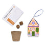 Introducing Home Grown Ornaments by Modern Sprout—a charming lavender grow kit that includes a packet labeled English Lavender, two soil pellets, a biodegradable pot, and a decorative house-shaped box with a ribbon. It’s the perfect ornament gift for any plant lover.