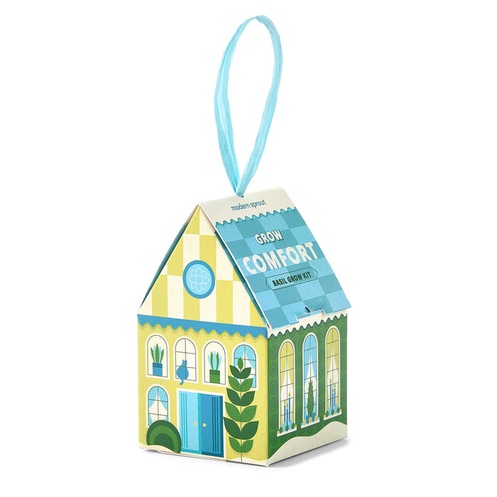 A charming house-shaped box from Modern Sprout’s Home Grown Ornaments collection, decorated with blue and green patterns, windows, a door, and plants, and topped with a blue ribbon—this unique ornament gift is both decorative and functional, doubling as a basil-growing kit for herb enthusiasts.