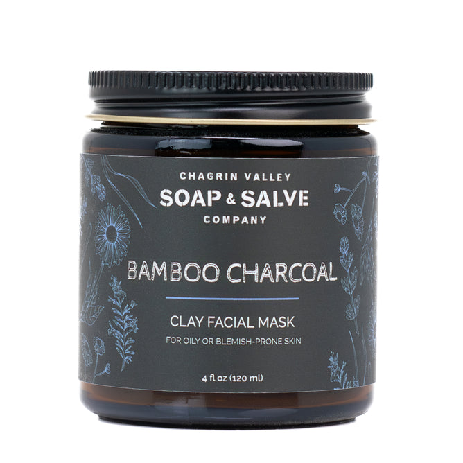 A 4 fl oz (120 ml) jar of Chagrin Valley Soap & Salve Activated Charcoal Clay Face Mask for oily or blemish-prone skin, with a black lid and floral label design.