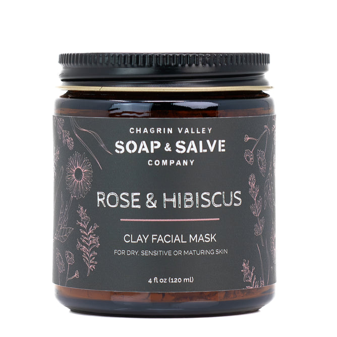 A 4 oz dark amber jar from Chagrin Valley Soap & Salve, labeled "Rose & Hibiscus Clay Face Mask," features floral designs and highlights organic hibiscus and French Pink Kaolin Clay. Ideal for dry, sensitive, or maturing skin.