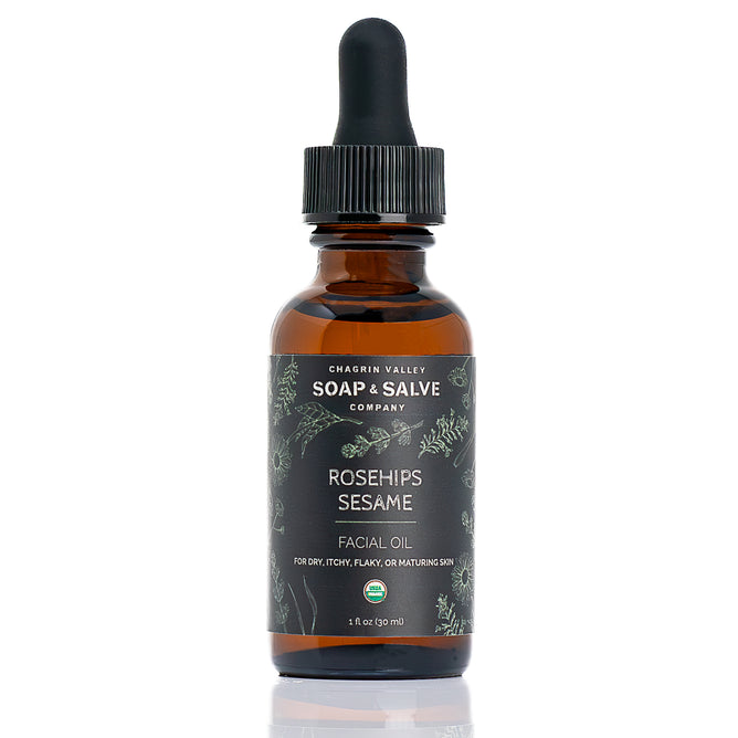 A 1 fl oz (30 ml) brown glass dropper bottle of Chagrin Valley Soap & Salve Facial Oil for dry, itchy, flaky, or maturing skin, featuring a black cap.
