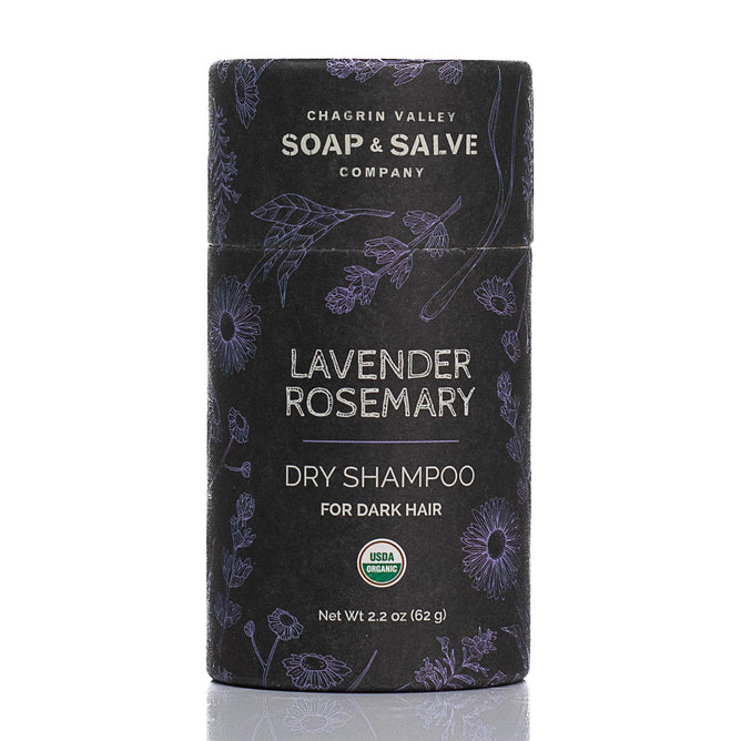 A cylindrical container of Chagrin Valley Soap & Salve Dry Hair Shampoo: Dark Hair features a floral design on a dark background and displays the USDA Organic label on the front.
