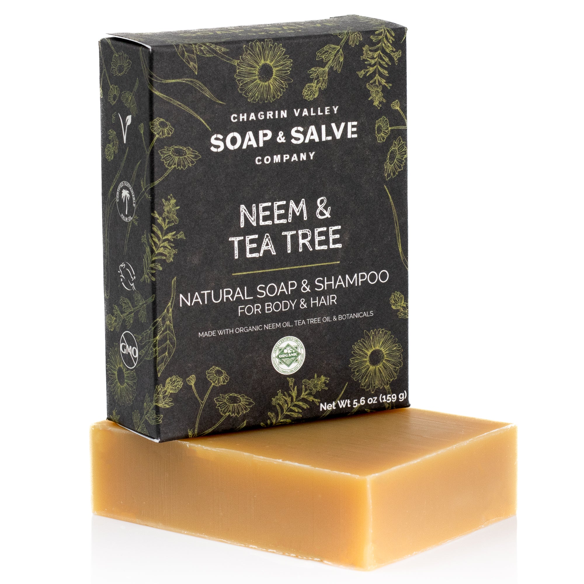 A rectangular brown Natural Shampoo and Soap Bar from Chagrin Valley Soap & Salve is displayed in front of a black, floral-patterned box, highlighting its versatility for body and hair.