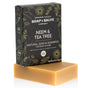 A rectangular brown Natural Shampoo and Soap Bar from Chagrin Valley Soap & Salve is displayed in front of a black, floral-patterned box, highlighting its versatility for body and hair.