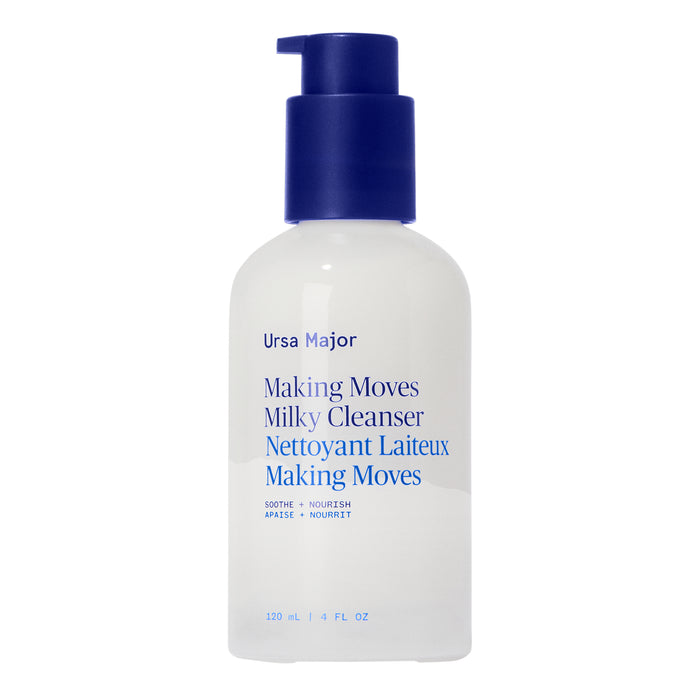 A white bottle of Ursa Major’s Making Moves Milky Cleanser with a blue pump and blue label text stands upright on a white background; this enzyme-powered facial milk gently exfoliates and hydrates.