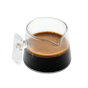 A Pure Over Espresso Measuring Glass / Coffee Dosing Glass, filled with dark espresso and topped with rich crema, sits on a white background.