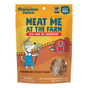 A package of Shameless Pets Dog Treats labeled Meat Me At The Feast, featuring a cartoon dog holding a pitchfork near a barn and a cow. The product highlights real beef as the main ingredient.