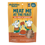 A bag of Shameless Pets Dog Treats – Meat Me At The Feast, featuring cartoon dogs holding drumsticks, showcases real turkey as the main ingredient and emphasizes that the treats are free from grain, corn, and soy.