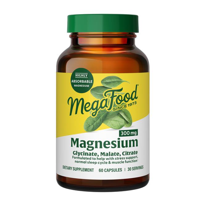A brown bottle of MegaFood Magnesium 300 mg with a yellow and green label contains 60 capsules (30 servings). This triple magnesium complex blends glycinate, malate, and citrate forms for highly absorbable support.