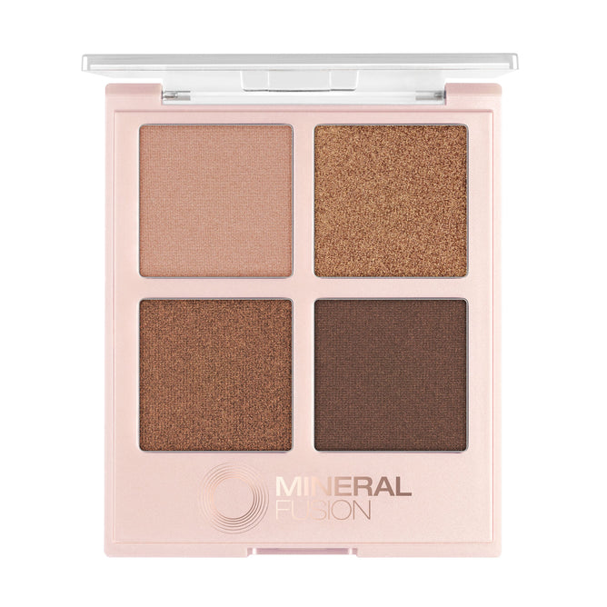 The Mineral Fusion Eye Shadow Palette features four vegan, crease-resistant neutral shades—light beige, gold, bronze, and dark brown—in a square pink case with an open lid that clearly displays the fade-resistant colors.