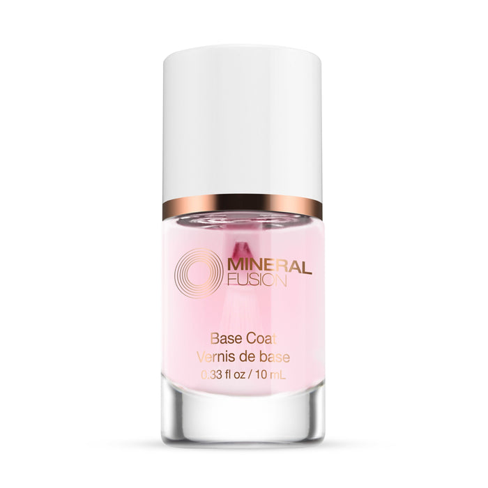 A 0.33 fl oz (10 mL) bottle of Mineral Fusion Nail Treatment Base Coat, featuring a white cap, clear body with pink liquid, and gold and white text. The vegan formula supports healthier nails.