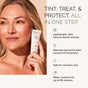 A blonde woman holds MDSolarSciences Mineral Tinted Crème SPF 30, a lightweight mineral sunscreen that’s safe for sensitive or acne-prone skin, reef friendly, and water resistant for up to 80 minutes.