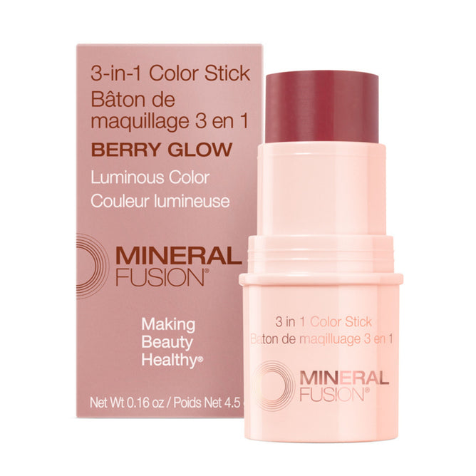 A pink tube of Mineral Fusion 3-in-1 Color Stick in Berry Glow stands before its matching box, showing its cheek and lip tint uses, with English and French product details on both the packaging and stick.