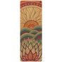 The Mountain Magic Aura Cork Yoga Mat by Yoloha Yoga is a sustainable yoga mat featuring a colorful design with a stylized sun rising over wavy hills and layered lotus petals in orange, green, and purple tones.