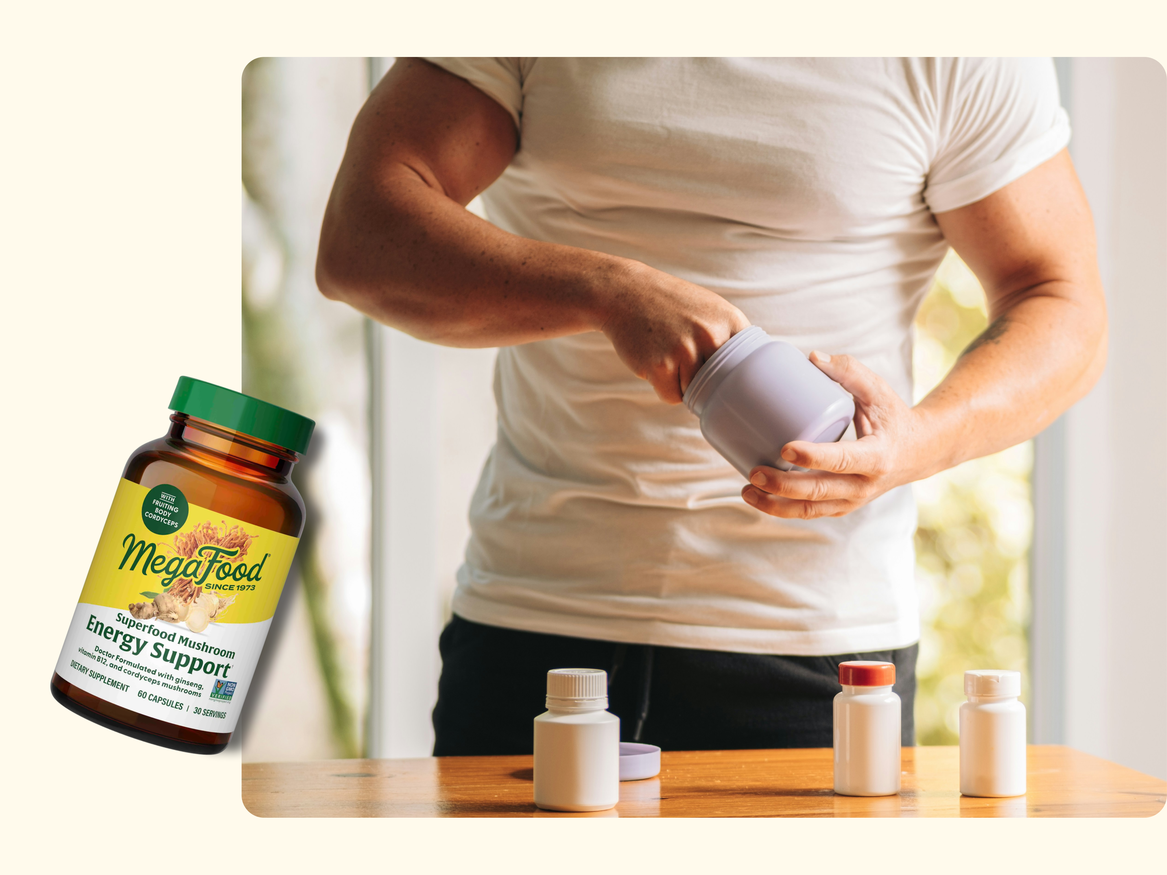 A muscular person in a white t-shirt opens a supplement container on a table with several other bottles. An image of a MegaFood Energy Support supplement bottle appears in the corner.