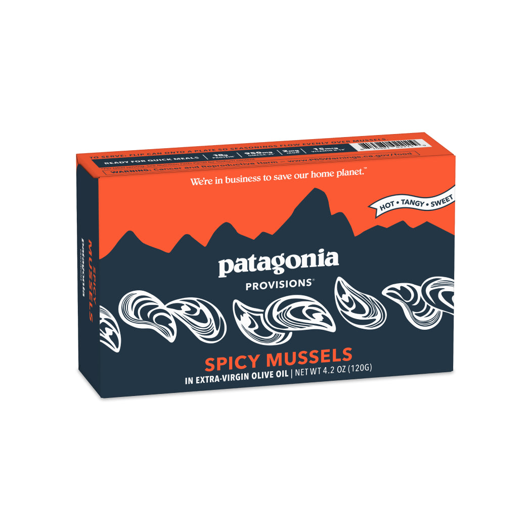 A 4.2 oz box of Patagonia Provisions Mussels Spicy in extra virgin olive oil, responsibly sourced, with an orange and navy design featuring mussels and mountains. Labeled Hot • Tangy • Sweet. Net weight: 120g.