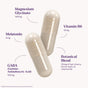 Shown are two clear capsules containing light beige powder. Surrounding text lists ingredients: Magnesium Glycinate (100mg), Melatonin (5mg), GABA (100mg), Vitamin B6 (10mg), and a Botanical Blend—Natrol Sleep & Restore Capsule with Melatonin.