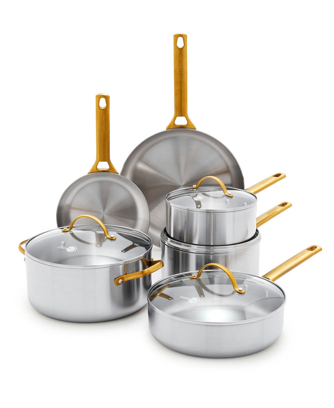 The GreenPan Reserve Stainless Steel Cookware Set features tri-ply stainless steel, gold-colored handles, two frying pans, two covered saucepans, a covered sauté pan, and a large covered pot—all PFAS-free and arranged on a white background.