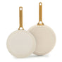 The GreenPan Reserve Pro Frypan Set features two beige ceramic nonstick pans with gold handles, one showing the cooking surface and the other the bottom—ideal for PFAS-free cooking.
