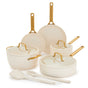 The GreenPan Reserve Pro Cookware Set features cream-colored ceramic nonstick pans with gold handles: two frying pans, a saucepan, sauté pan, Dutch oven, matching lids, spatula, and spoon. PFAS free and elegantly displayed on a white background.