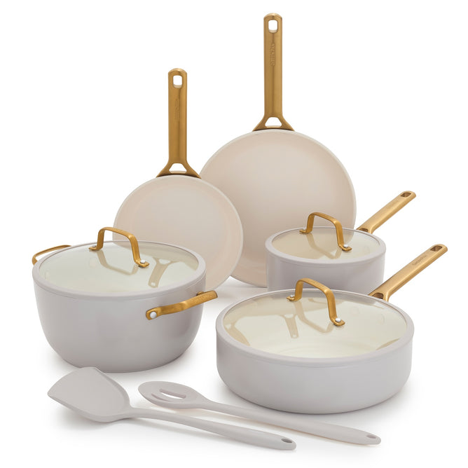 The GreenPan Reserve Pro Cookware Set is a PFAS-free white ceramic nonstick set with gold handles. It includes 2 frying pans, 2 saucepans with lids, 1 stockpot with lid, and 2 utensils, all displayed on a white background.
