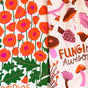 The Neighborgoods Dish Towel Set includes two colorful cotton towels: one with orange poppies and green stems, and another with mushrooms in brown, orange, and pink plus “Fungi Awesome.” A fun way to brighten your kitchen.