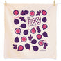 A cream cotton dish towel from The Neighborgoods features purple and pink figs—whole and halved—with playful Get figgy with it text in the center.