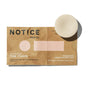 The Fixer Conditioner by NOTICE Hair Co is a round, off-white, plastic-free bar on brown packaging. It repairs damaged hair and features soothing lavender and sweet basil aromas.