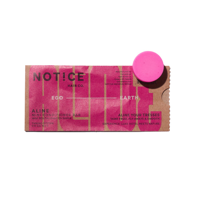 A rectangular package with a hot pink and brown design labeled NOT!CE Hair Co and ALINE Mini Conditioner Bar - Sample, next to a round pink vegan conditioner bar that helps tame frizz.