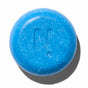 A round, blue NOTICE Hair Co "Kids Shampoo Bar - For Tangles" with a slightly textured surface and an embossed N. in the center, designed for fine hair and gentle detangling, casts a shadow on a white background.