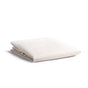 The Naturepedic Fitted Waterproof Crib Mattress Protector Pad, in off-white organic material, is neatly folded and displayed on a white background.