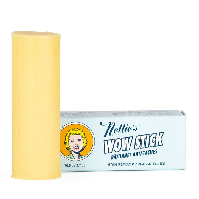 A yellow WOW Stick Stain Remover by Nellie’s stands upright beside its blue retro box labeled “Nellie’s WOW Stick,” “Stain Remover,” and “76.5g / 2.7 oz,” highlighting its natural, effective green cleaning power.