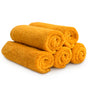 Five orange Natemia Organic Super Absorbent Washcloths, made from 100% GOTS Certified Organic Cotton, are rolled up and stacked in a pyramid shape against a white background.