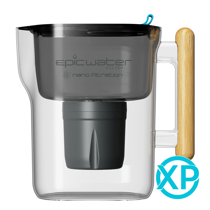 A transparent Nano XP Water Filter Pitcher by Epic Water Filters USA features a black filter labeled “epicwater filters nano filtration” and a wooden handle. This NSF certified pitcher, designed for advanced water filtration—including the reduction of bacteria and PFAS—displays a blue XP logo at the bottom right corner.