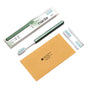 The Nada Soft Adult Toothbrush, featuring a green handle and white head, comes with two replacement brush heads, a brown envelope, and eco-friendly white and green “nada” packaging—all displayed on a white background.