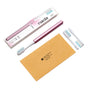 The Nada Medium Adult Toothbrush, in pink with a white and blue brush head, comes with two extra heads, a tan envelope, and branded box—displayed on white to highlight its sustainable oral care design.