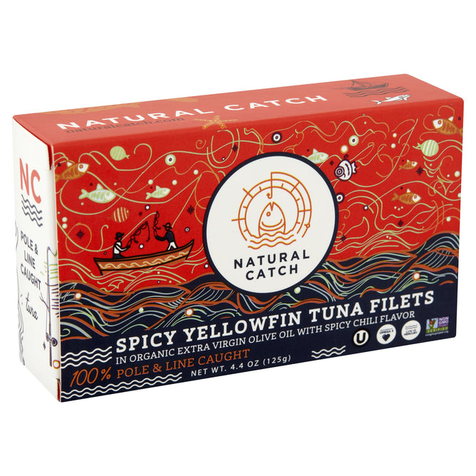 Natural Catch Spicy Yellowfin Tuna Filets in Extra Virgin Olive Oil feature a chili kick and Omega-3s. In red and navy packaging with a fishing boat, fish illustrations, and “100% pole & line caught” displayed.