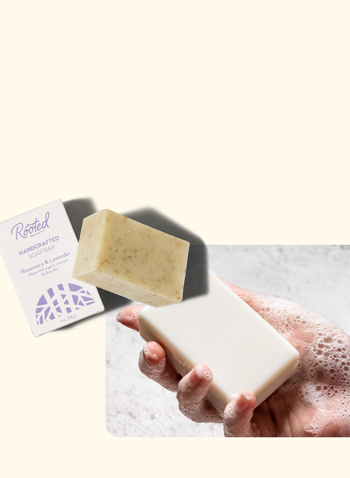 A hand holds a white bar of soap covered in lather. Next to it is an unused beige soap bar and its packaging labeled Rooted Handcrafted Soap Bar, Rosemary & Lavender.