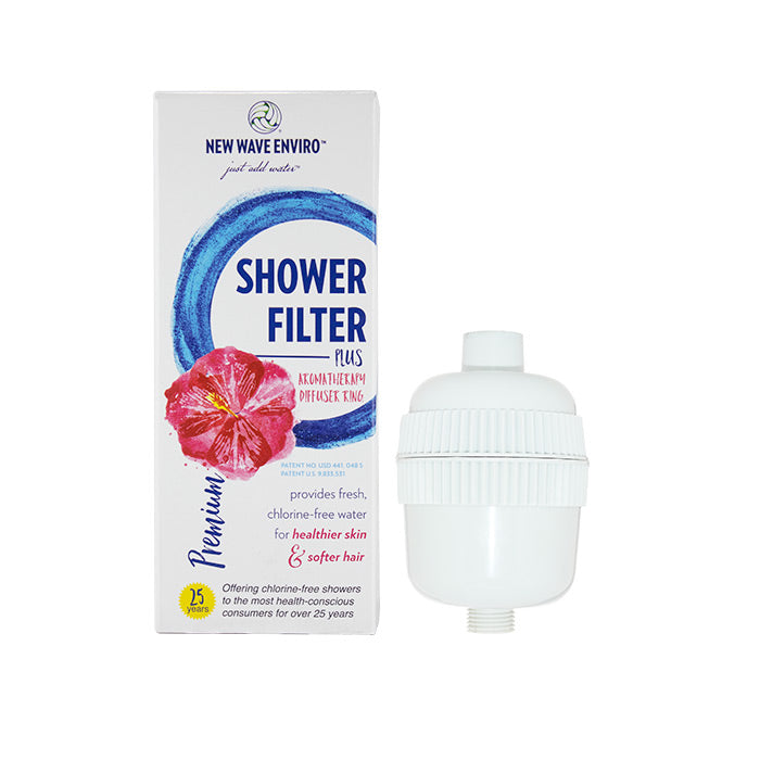 The white New Wave Enviro Premium Shower Filter is shown beside its box, featuring a pink flower, blue swirl, and text promoting aromatherapy shower benefits, softer hair, and powerful chlorine reduction for cleaner water.