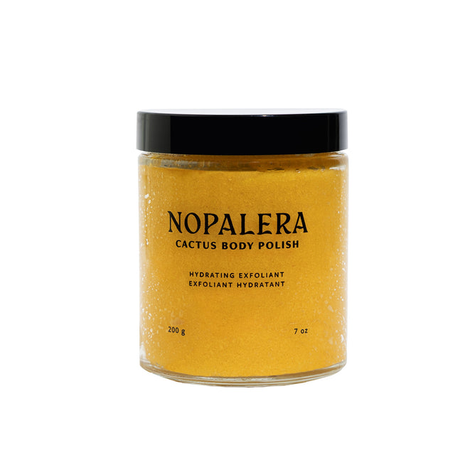 A clear jar with a black lid labeled NOPALERA Cactus Body Polish holds 200g (7oz) of yellow exfoliant that hydrates and gently moisturizes the skin.